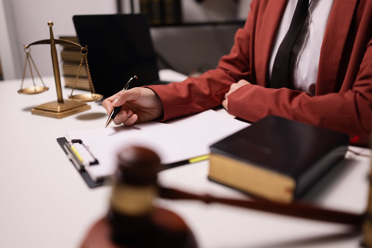 Legal document preparer working with signature documents in a modern office