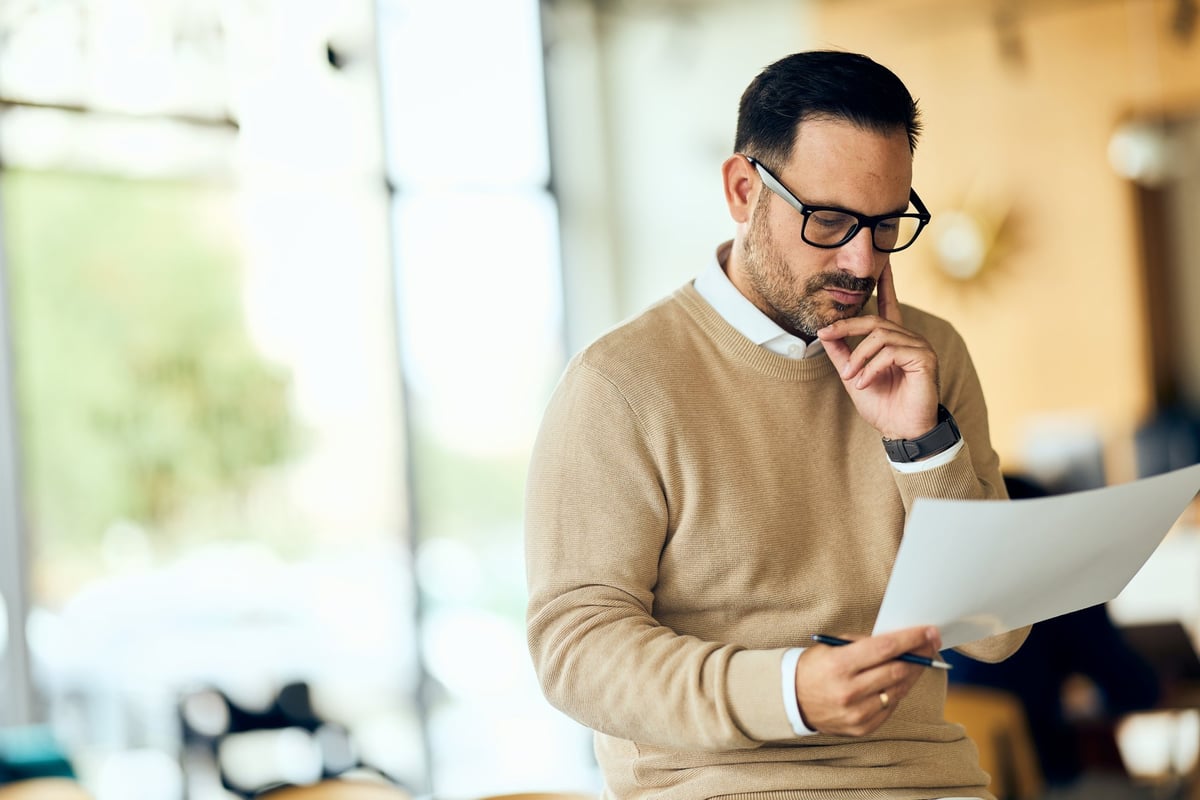Professional reading a legal document in a bright office