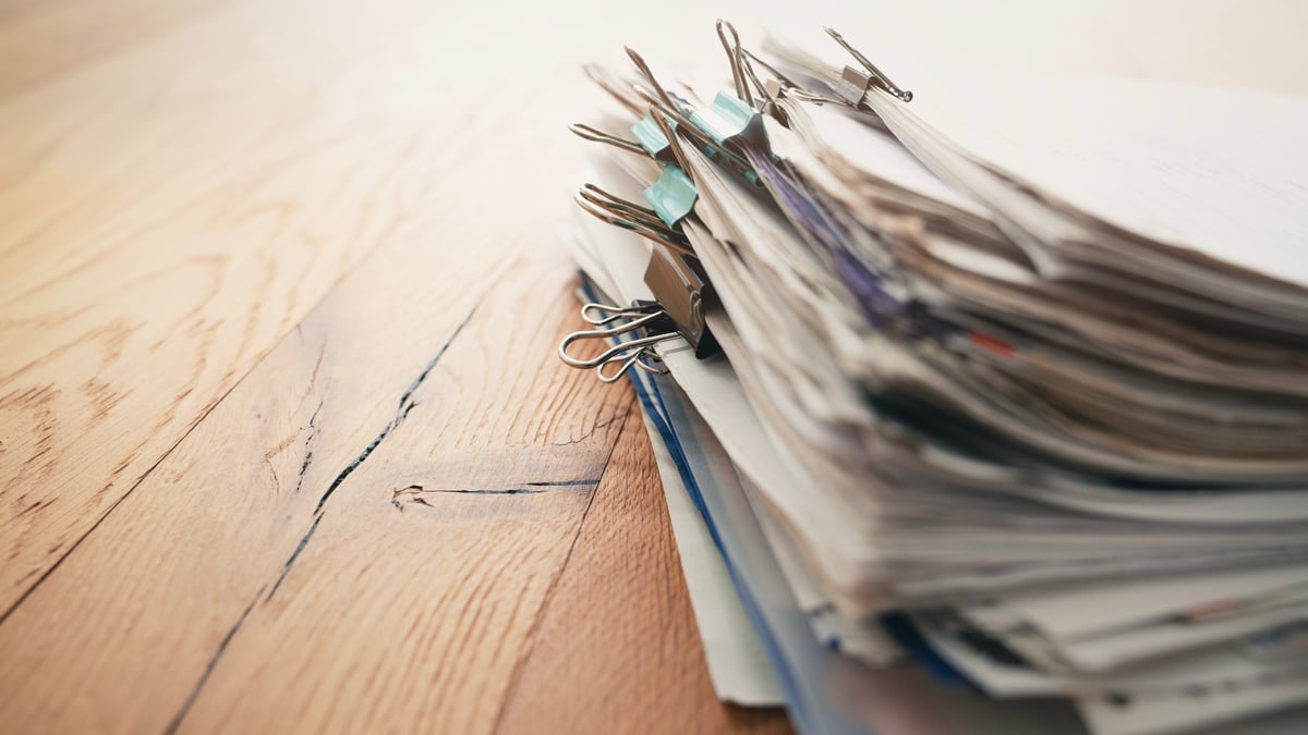 Pile of organized legal paperwork on an office desk